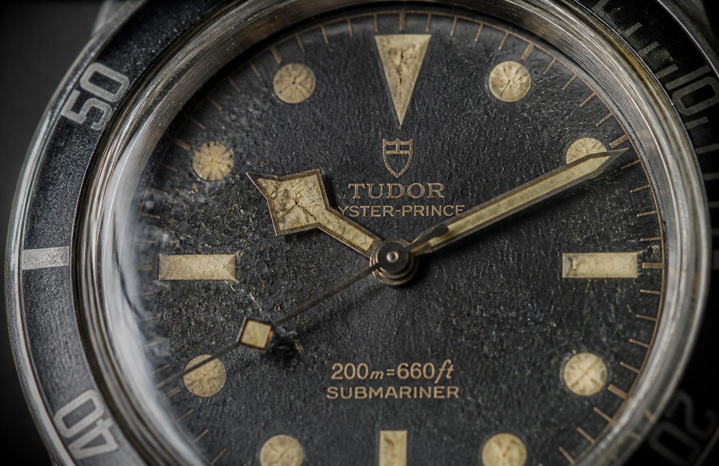 Extreme macro of an antique watch dial with cracked, yellowed luminous paint on the markers and hands